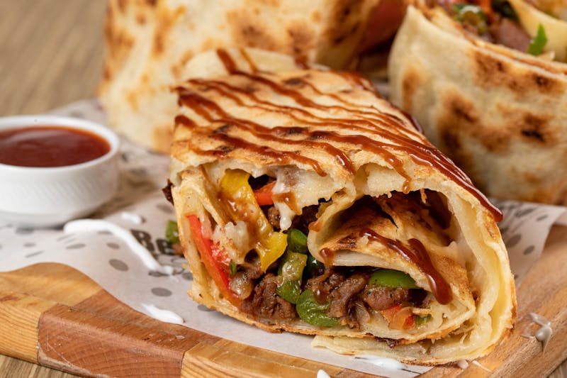 Steak burrito with rice, beans, and cheese